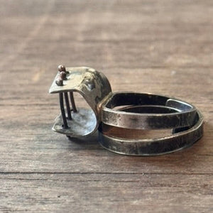 Sterling silver patina ring with small bars across open section of ring