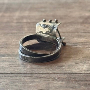 Sterling silver patina ring with small bars across open section of ring